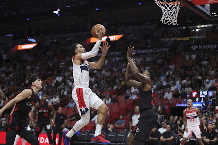 Washington Wizards guard Tyus Jones (5) drives to the basket against Miami Heat forward Haywood Highsmith (24) during the first quarter at Kaseya Center.